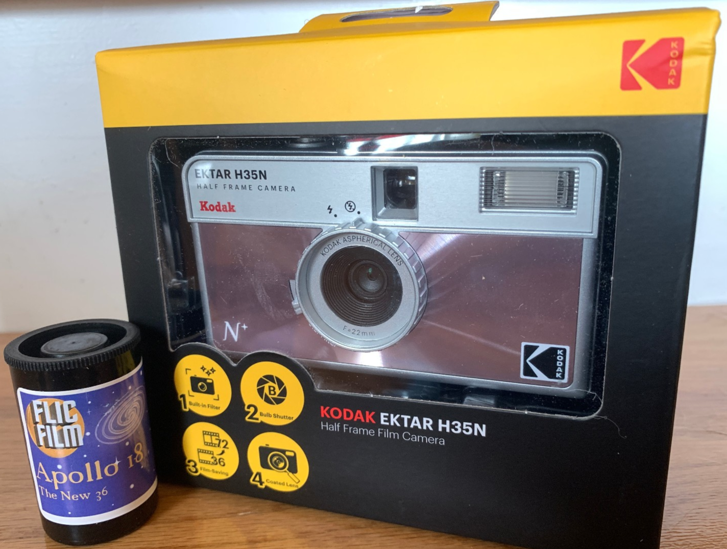 Kodak Ektar H35N 35mm half-frame film camera in glazed pink, with film and filters
