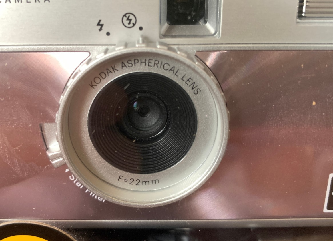 Kodak Ektar H35N 35mm half-frame film camera in glazed pink, with film and filters