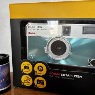 Kodak Ektar H35N 35mm half-frame film camera in glazed blue, with film and filters