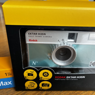 Kodak Ektar H35N 35mm half-frame film camera in glazed blue, with film and filters