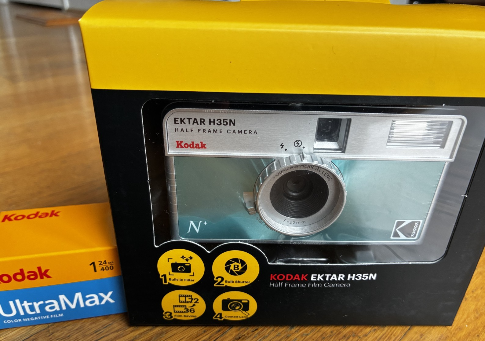 Kodak Ektar H35N 35mm half-frame film camera in glazed blue, with film and filters