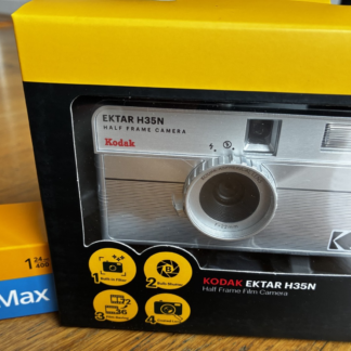 Kodak Ektar H35N 35mm half-frame film camera in striped silver, with film and filters
