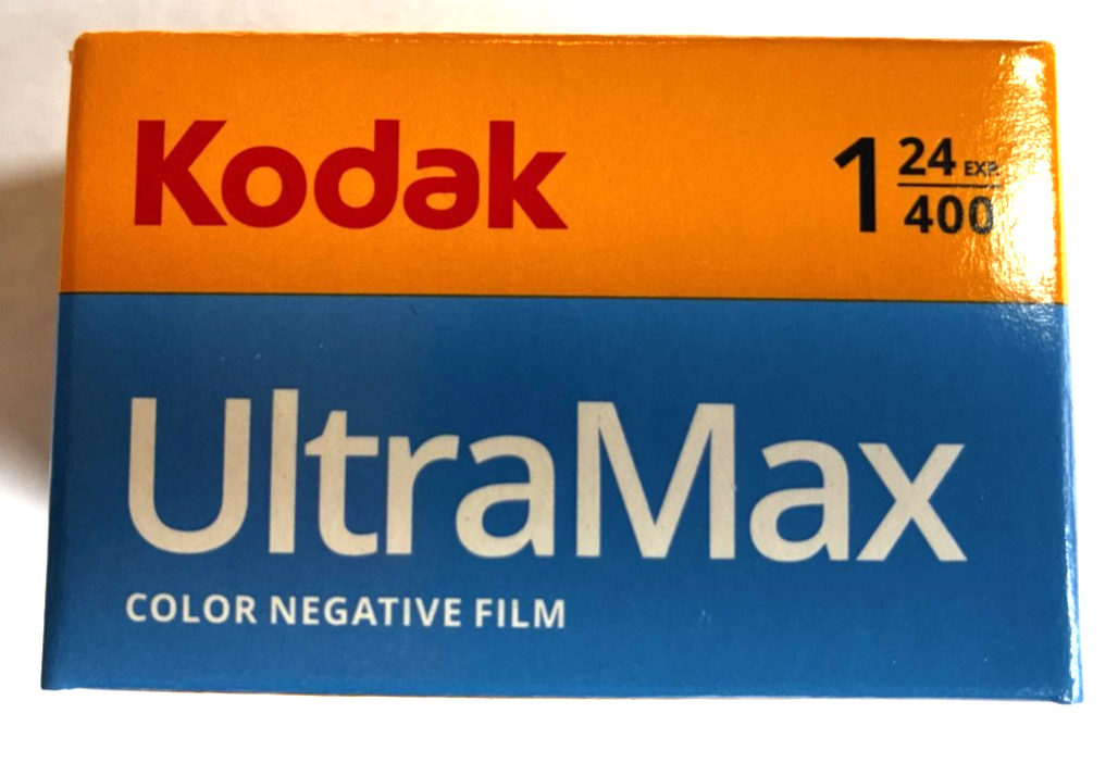 Kodak Ektar H35N 35mm half-frame film camera in striped silver, with film and filters