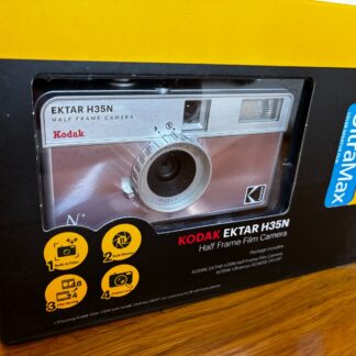 Kodak Ektar H35N 35mm half-frame film camera in glazed pink, with film and filters