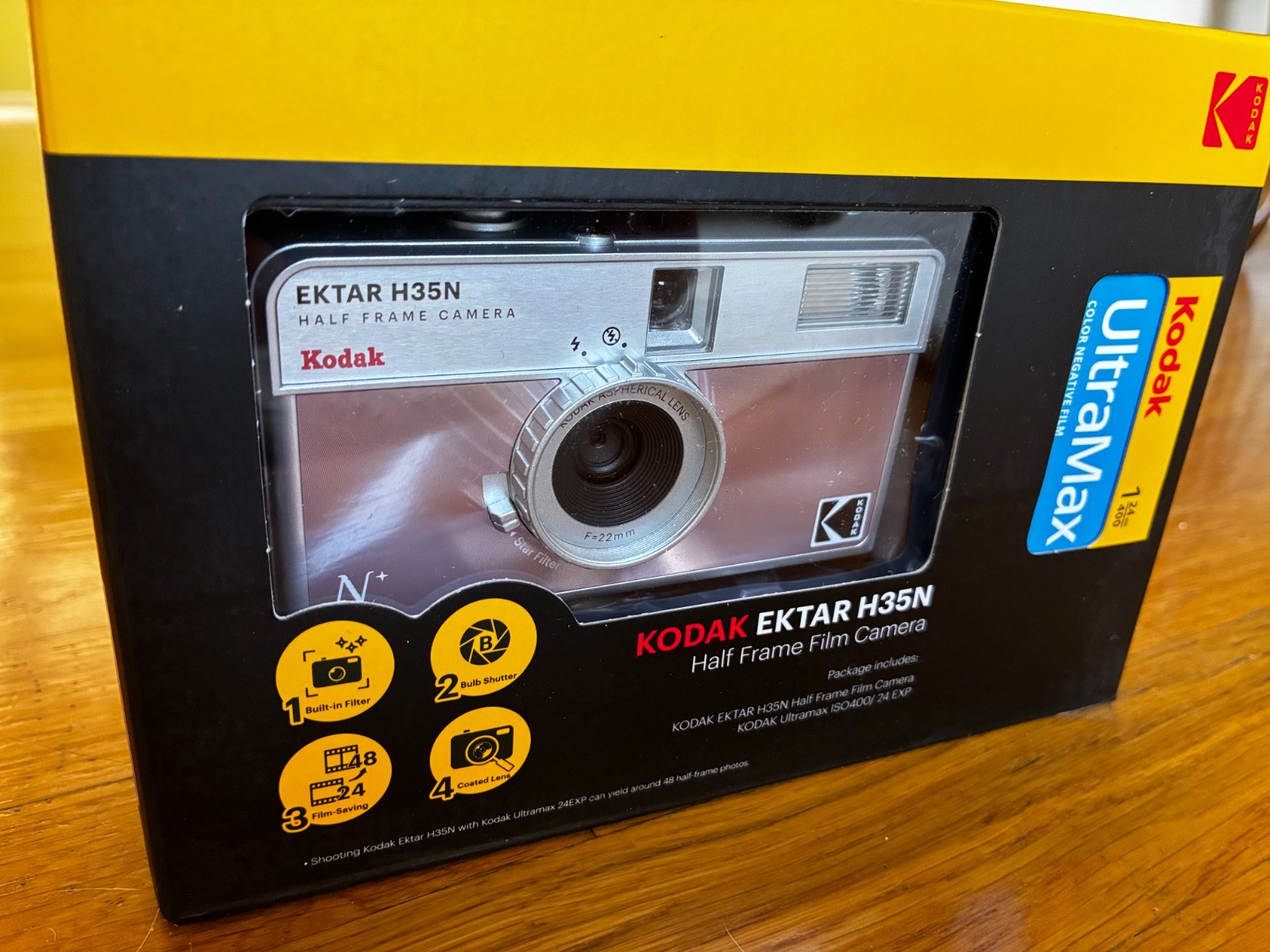 Kodak Ektar H35N 35mm half-frame film camera in glazed pink, with film and filters