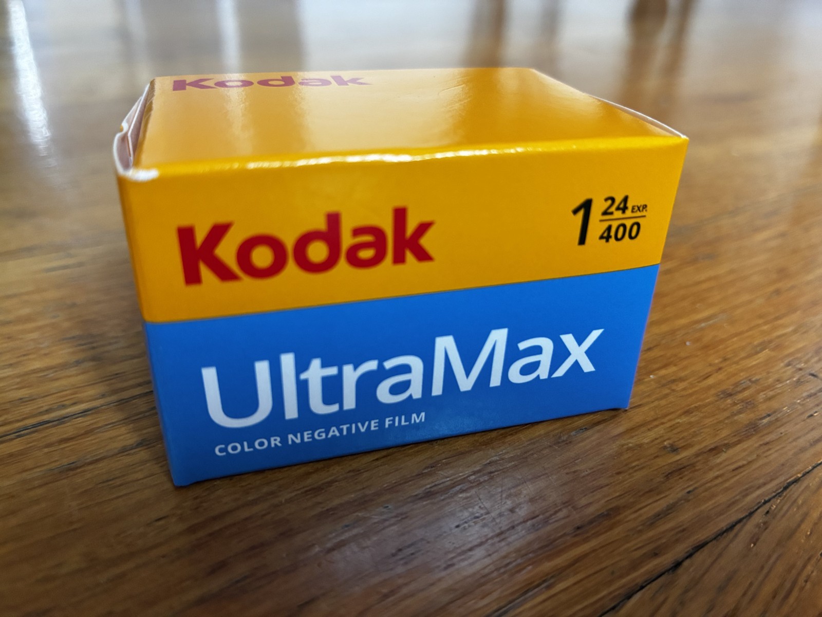 Kodak Ektar H35N 35mm half-frame film camera in glazed pink, with film and filters